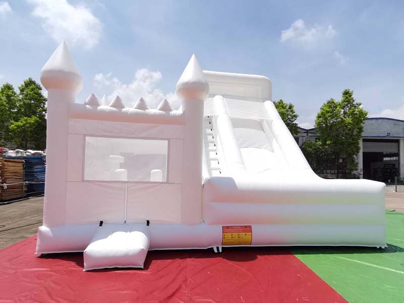 Commercial grade white bounce house with slide and climbing wall